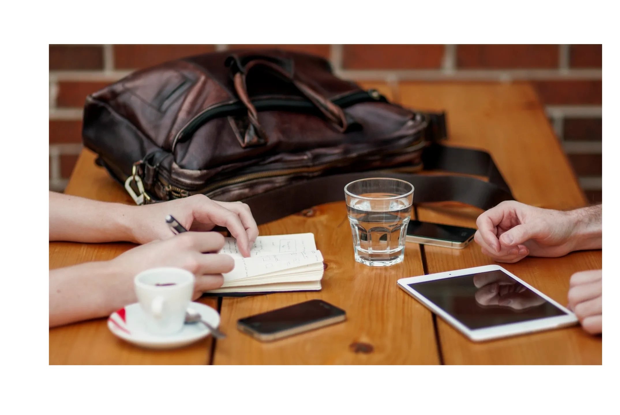 Overhead view of business meeting with notebook and tablet